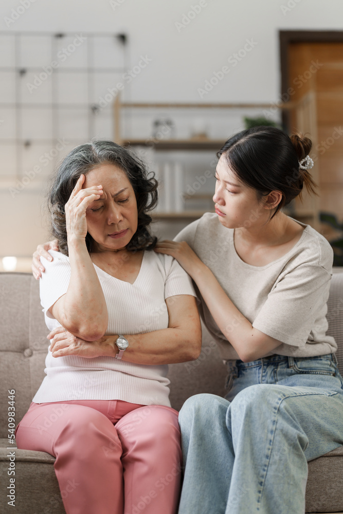 Sad asian mature woman grown up daughter or grandkid sitting on sofa hugging desperate, My heart warms to you, dear mommy.