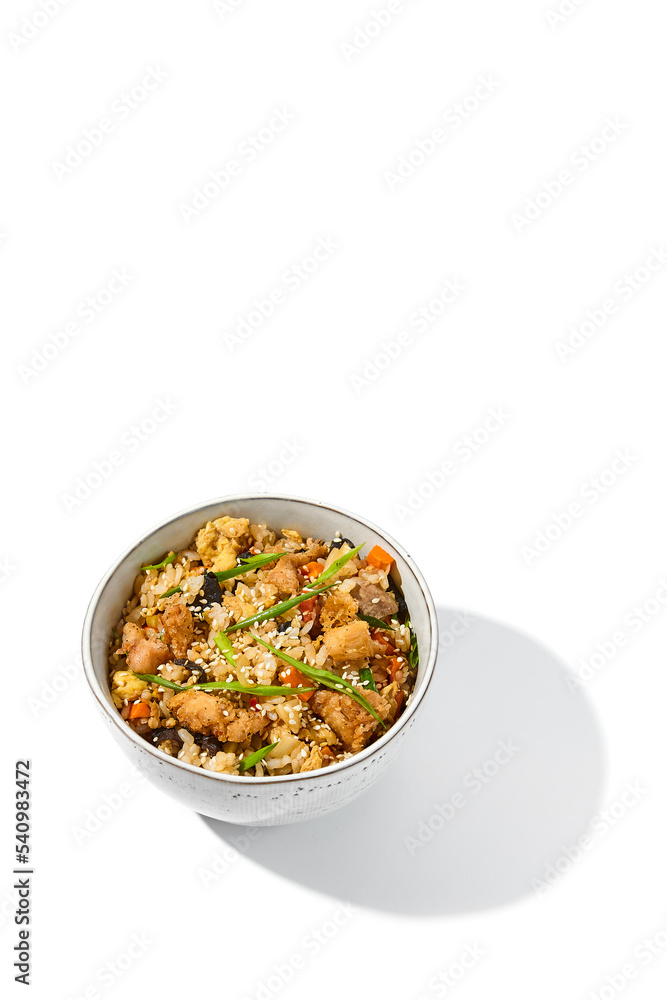 Fried rice with egg, chicken and vegetables isolated on white background. Traditional chinese food - fried rice with chicken meat in ceramic bowl Nasi goreng with fried rice, chicken and egg Fried rice with egg, chicken and vegetables isolated on white background. Traditional chinese food - fried rice with chicken meat in ceramic bowl Nasi goreng with fried rice, chicken and egg