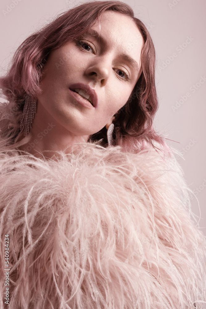 Elegant young woman posing in stylish feathers dress. Vertical mock-up. Elegant young woman posing in stylish feathers dress. Vertical mock-up.