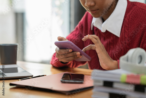 Portrait of Happy black woman reading phone message