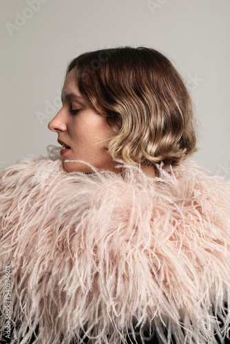 Profile photo of young woman wearing stylish feathers dress. Vertical mock-up.