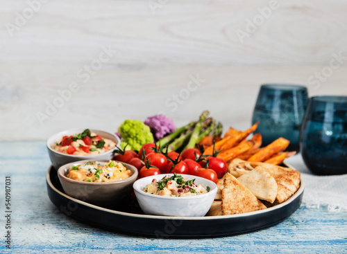 Party platter of dips, vegetables and pita bread