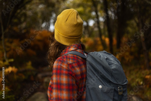 Wallpaper Mural A caucasian woman hiker with a backpack standing on a path in an autumn forest. Torontodigital.ca