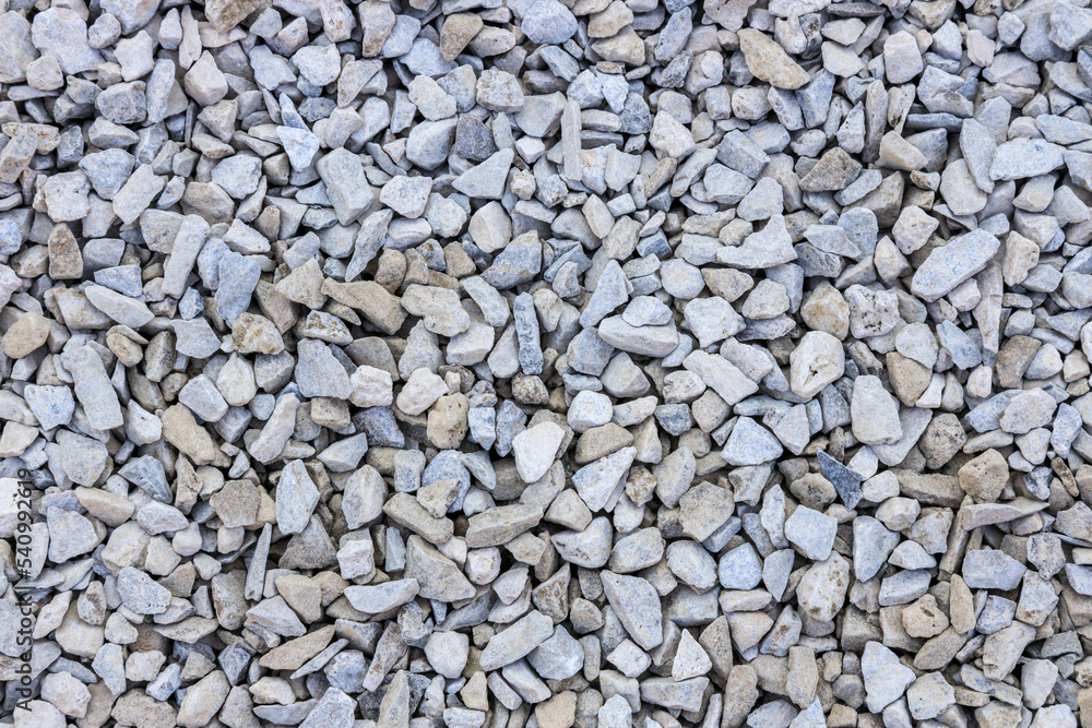 background of stone pebbles pattern, tan, gray and white rocks background of stone pebbles pattern, tan, gray and white rocks