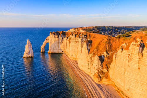 Normandy, France. Etretat village cliffs with the Porte d'Aval arch and the rock known as the Aiguille d'Etretat.