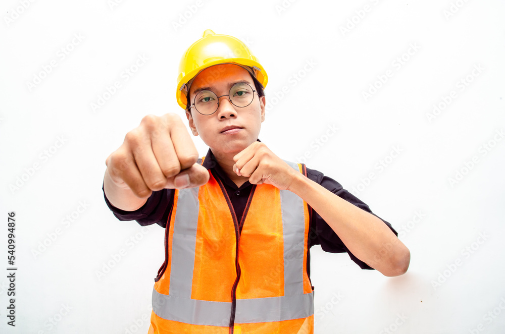 young asian male construction worker or engineer shows expresion of anger and furious looking for fight and threatening isolated over. stressed over work concept