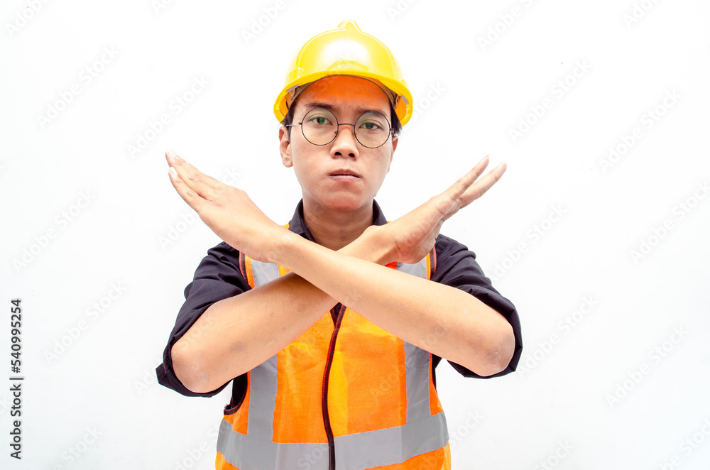young asian male construction worker or engineer using yellow helmet and orange vest refuse and reject something. asian male worker makes stop gesture isolated over red background.