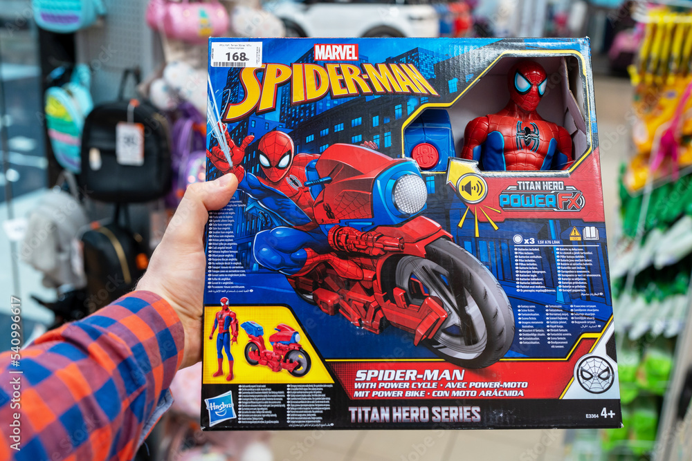 Obraz premium Spiderman toy with power bike in a toy store. Buyer Choosing Spider-Man Figure. Minsk, Belarus, 2022