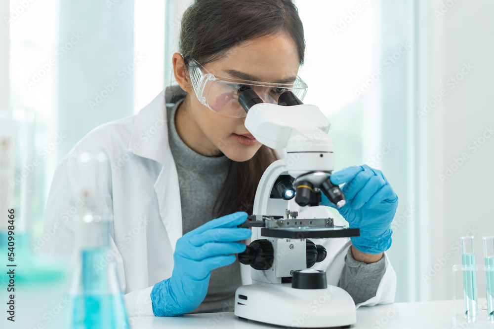researcher using microscope analyse cell in medical lab. researcher using microscope analyse cell in medical lab.