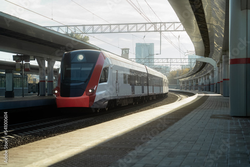 City train drive on railroad at the platform train station. Transportation background in sunny day
