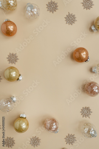 Christmas, New Year holidays composition. Frame with blank copy space. Gold Christmas baubles balls, stars on neutral beige background. Flat lay, top view festive mockup