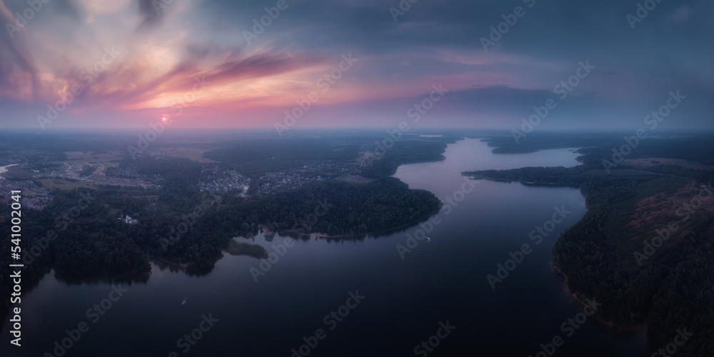 Nature landscape, drone aerial top view to green forest and lake at dramatic sky sunset. Istrinskoye Vodokhranilishche