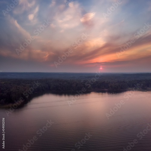 Nature landscape  drone aerial top view to green forest and lake at dramatic sky sunset. Istrinskoye Vodokhranilishche