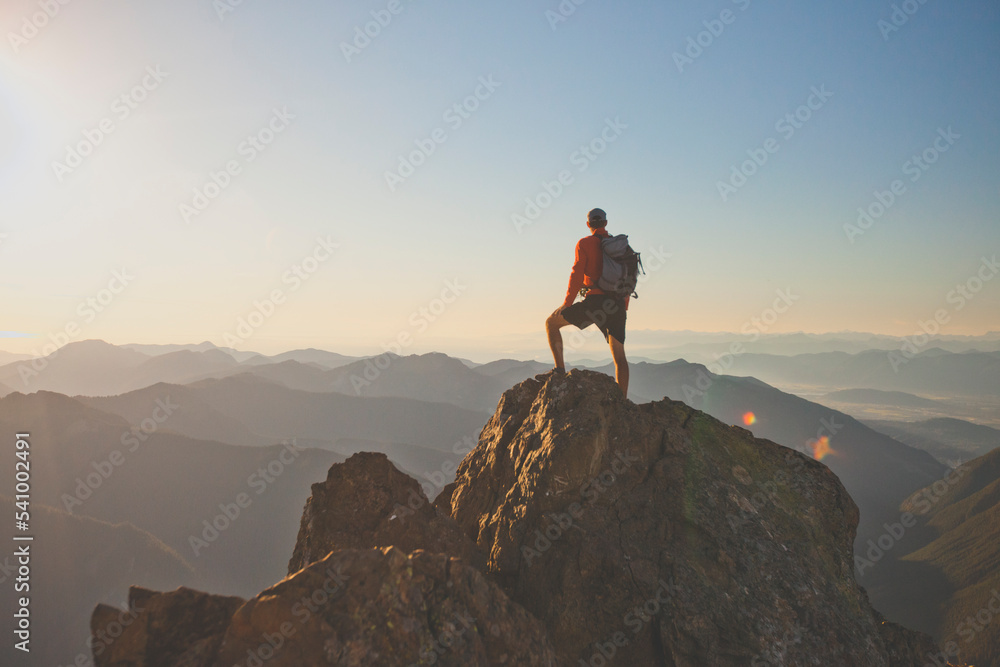 © Cavan Images - Backpacker standing on mountain peak, North Cascades National Park, Washington State, USA