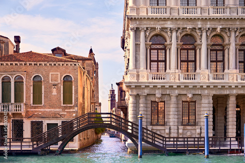 Romantic Venice, bridge over canal in Rezzonico, quiet Dorsoduro part of Venice, Italy. Palazzo and traditional house standing in green water of Grand Canal. photo