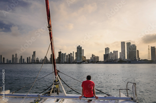 Man looking at city of Cartagena from catamaran, Bolivar Department, Colombia photo