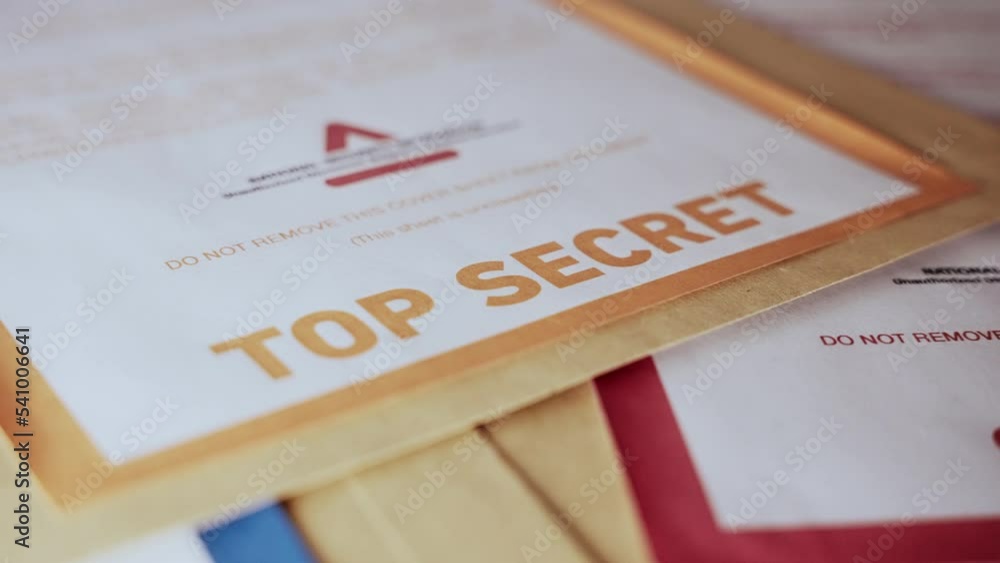 Close up on modern Top Secret label on yellow brown document folder