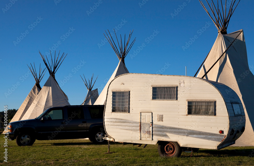 A tepee stands alongside a camper and truck and an Indian dance in Northern California. A tepee stands alongside a camper and truck and an Indian dance in Northern California.