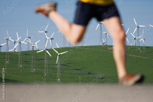 A man running near windmills on Patterson Pass near Livermore California. photo