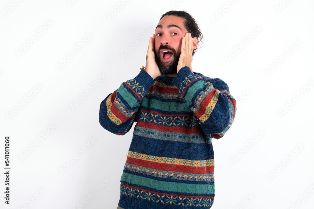 Caucasian man with beard wearing sweater over white background Pleasant looking cheerful, Happy reaction