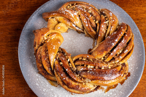 Roscón de reyes Kringle Estonia. Typical Christmas sweet, braided sponge cake with cinnamon, butter, walnuts or almonds and icing sugar.