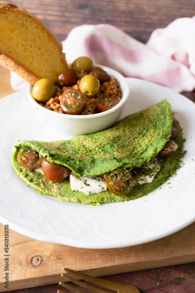 Spinach pancakes with cheese and cherry tomatoes with lentil salad. Ready-to-eat vegetarian food Spinach pancakes with cheese and cherry tomatoes with lentil salad. Ready-to-eat vegetarian food