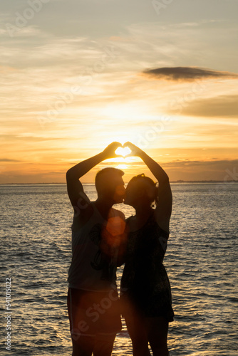 Silhouette of couple making heart shape with hands, Nusa lembongang, Bali, Indonesia photo