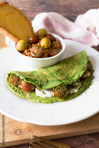 Spinach pancakes with cheese and cherry tomatoes with lentil salad. Ready-to-eat vegetarian food