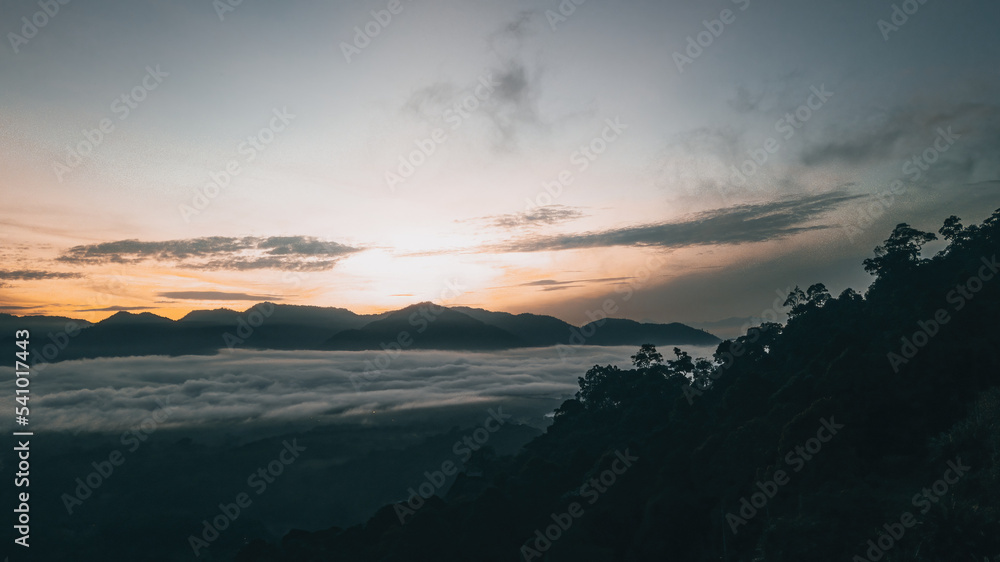 Sea clouds during golden sunrise above the mountains range in Lenggong, Perak.