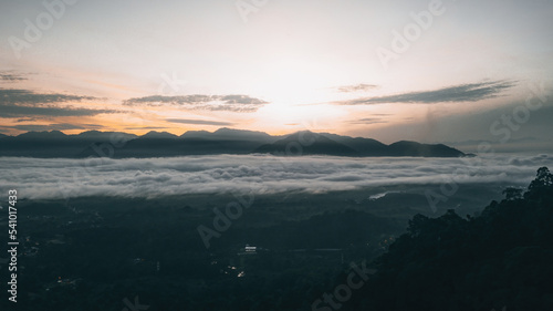 Sea clouds during golden sunrise above the mountains range in Lenggong, Perak. © ellinnur