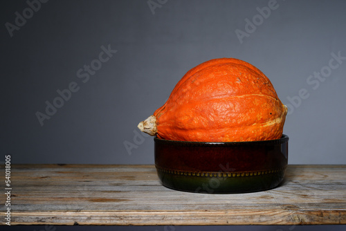 orange Hokkaido pumpkin in a ceramic bowl photo