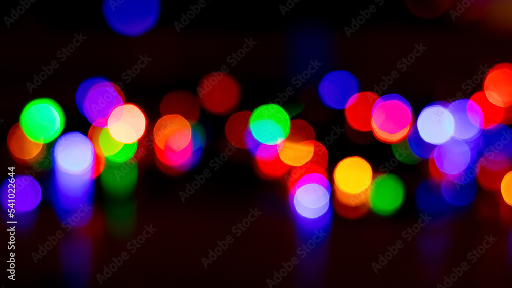 Abstract background with colorful sparkling bokeh on a dark background. Holiday concept Abstract background with colorful sparkling bokeh on a dark background. Holiday concept