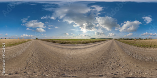 full hdri 360 panorama on no traffic gravel road among fields with overcast sky and white fluffy clouds in equirectangular seamless spherical projection,can be used as replacement for sky in panoramas