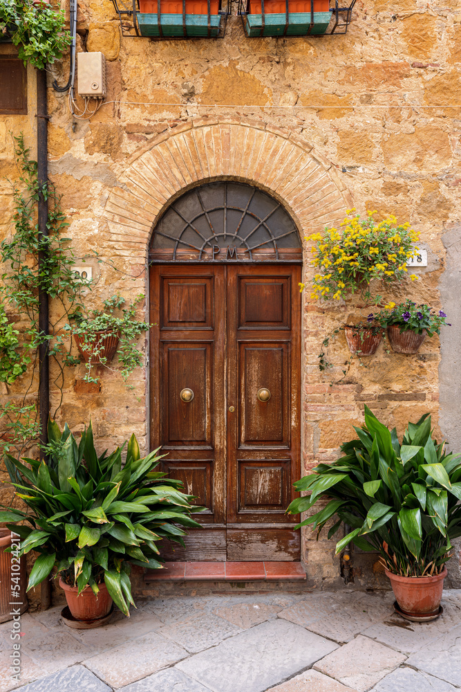 Old door in the historic town Pienza in the Val d'Orcia in Tuscany, Italy.