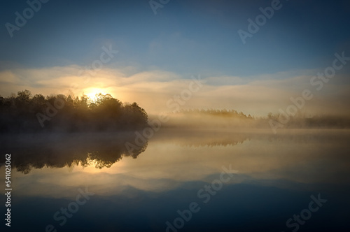 Sunrise over the foggy lake © Piotr Wawrzyniuk