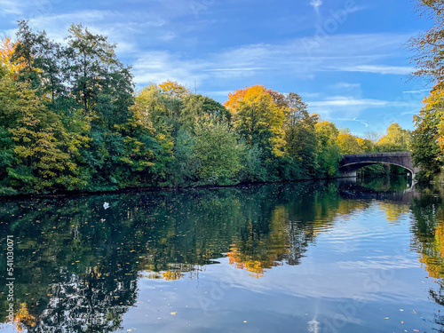 Autumn landscape along one of the many waterways that run through Hamburg. The river Wandse become the Eilbek canal and flows trough the eastern part of Hamburg into the river Alster photo