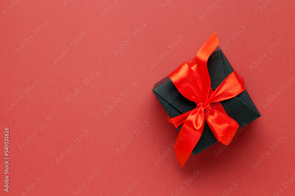 Black box with red bows on dark red background. Singles day 11.11 concept. Online shopping sale.