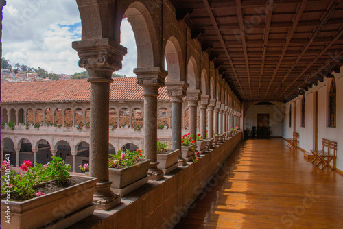 Corridor with arches and columns  adorned with flowers  in Qorikancha  Church and Convent of Santo Domingo de Guzm  n in Cusco. 