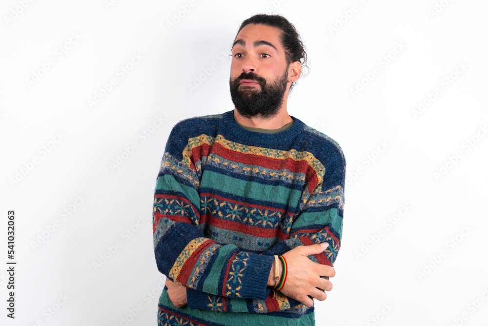 Caucasian man with beard wearing sweater over white background shaking and freezing for winter cold with sad and shock expression on face. Caucasian man with beard wearing sweater over white background shaking and freezing for winter cold with sad and shock expression on face.