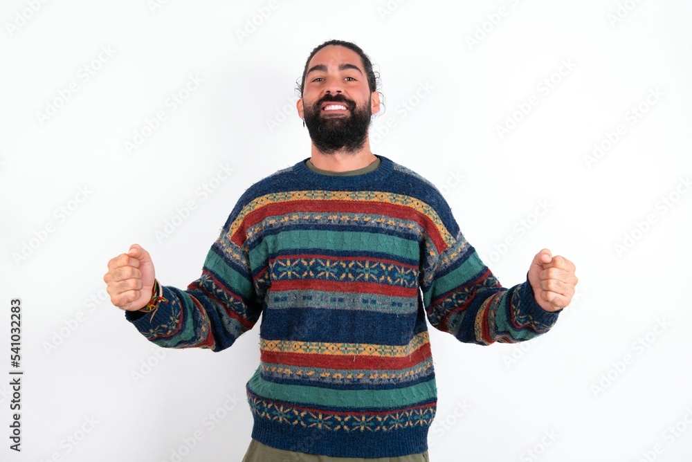 Happy Caucasian man with beard wearing sweater over white background Holding Empty Paper Board Advertising Offer Text Standing. Autumn Advertisement Banner. Happy Caucasian man with beard wearing sweater over white background Holding Empty Paper Board Advertising Offer Text Standing. Autumn Advertisement Banner.