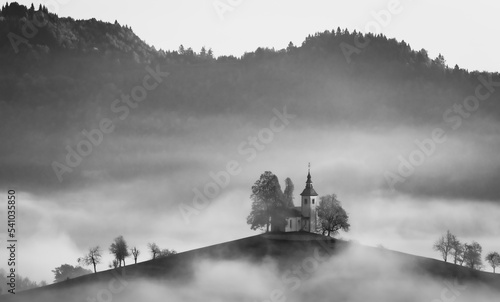 Cerkev Sveti Toma    St. Thomas Church  near   kofja Loka  Slovenia. Misty morning and sunrise