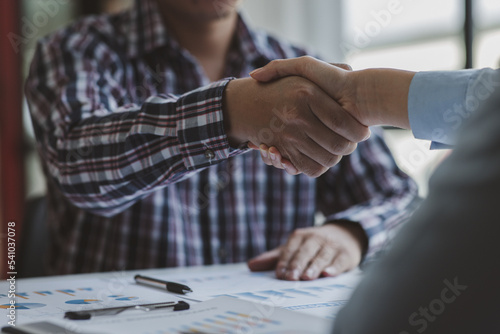 Business handshake for teamwork of business merger and acquisition,successful negotiate,hand shake,two businessman shake hand with partner to celebration partnership and business deal concept	 photo