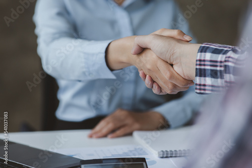 Business handshake for teamwork of business merger and acquisition,successful negotiate,hand shake,two businessman shake hand with partner to celebration partnership and business deal concept	 photo