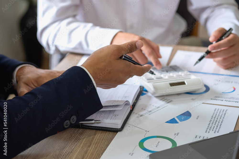 Fototapeta premium Marketing, Financial, Accounting, Planning, Team of business use calculators and graph analysis to plan marketing strategies and make profitable investments for the company.