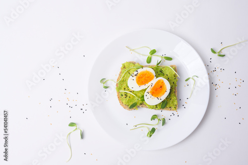 Bread with avocado , vegetables fruit and egg on white background , Healthy breakfast concept