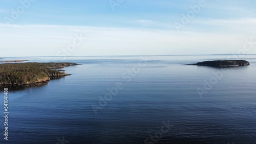 Scenic green coastline in the ocean on a sunny day