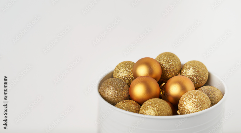 a cone full of golden Christmas balls with white background and space for copying a cone full of golden Christmas balls with white background and space for copying