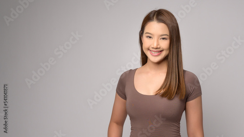 Portrait of young beautiful woman smiling over white background studio