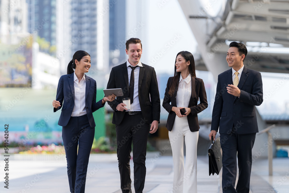 Business people walking and talk to each other in front of modern office Business people walking and talk to each other in front of modern office