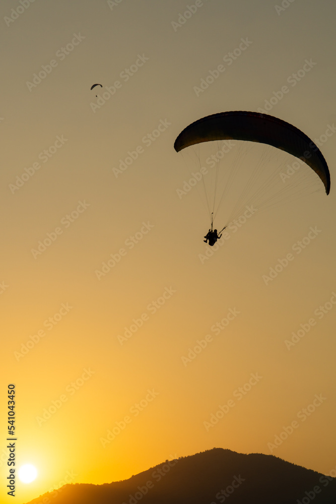 Parachutist flying in the sky at sunset Parachutist flying in the sky at sunset